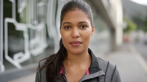 a young active female runner standing in the city