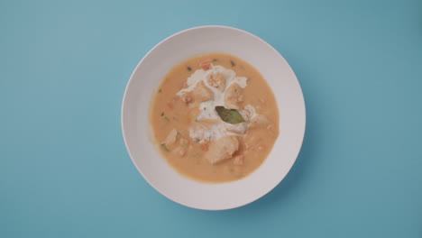 creamy chicken soup in a white bowl