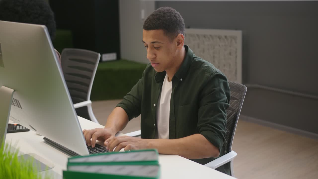 personas multinacionales se sientan en escritorios trabajando en computadoras