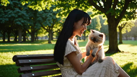 young woman and her cat enjoying golden hour in the park