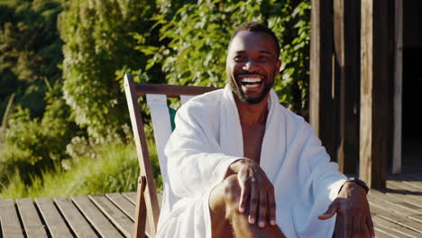 Two Happy Men in Bathrobes Enjoying a Sunny Conversation Outdoors