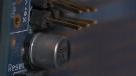 Close-up-macro-shot-of-a-metal-capacitor-on-a-system-board