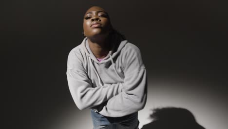 Studio-Portrait-Shot-Of-Young-Woman-Dancing-In-Spotlight-In-Real-Time