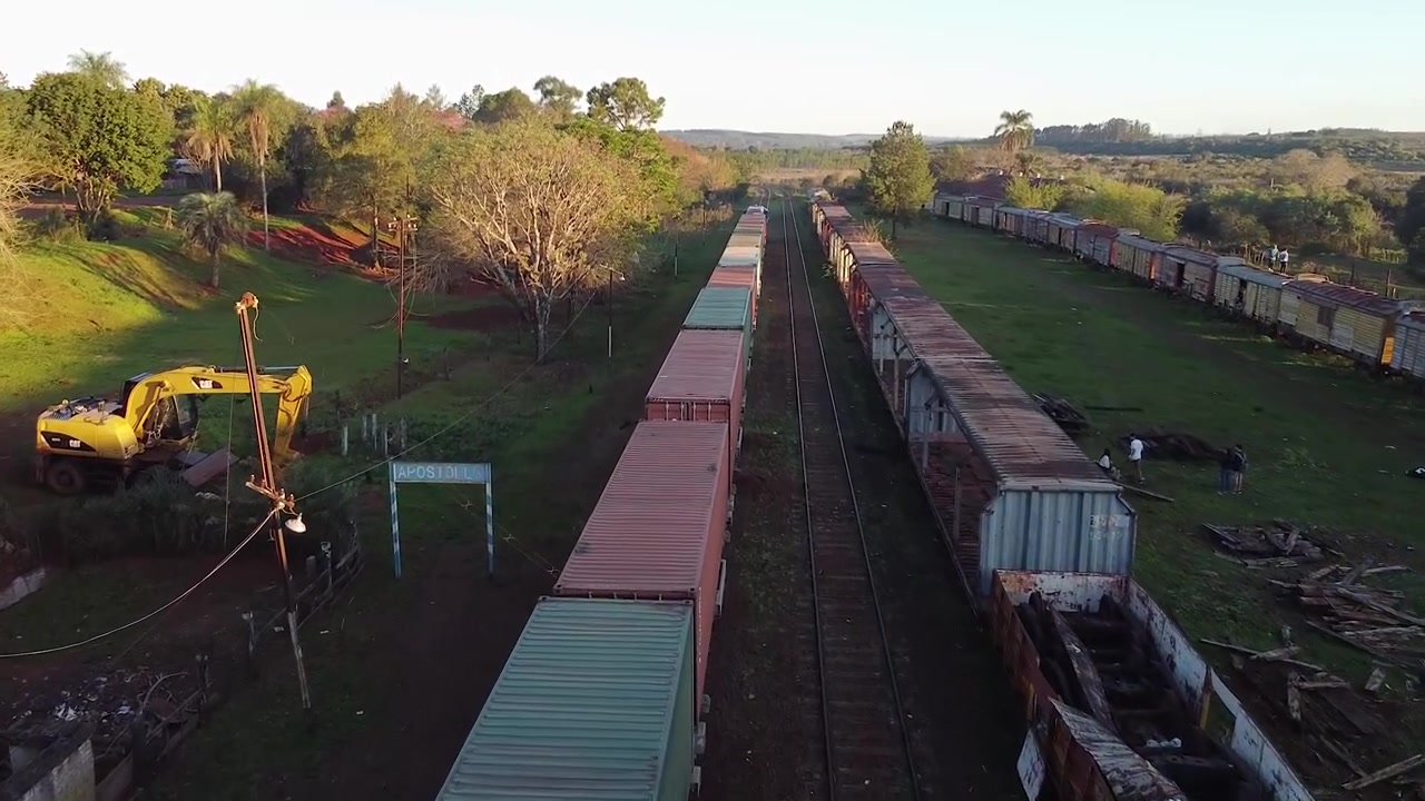 Drone following freight train through old train station in apostoles, argentina