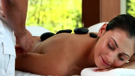 relaxed friends enjoying hot stone massages