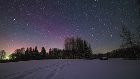 lighting stars,meteor and milky way galaxy at dark sky with different colors during cold winter day in wilderness - time lapse shot