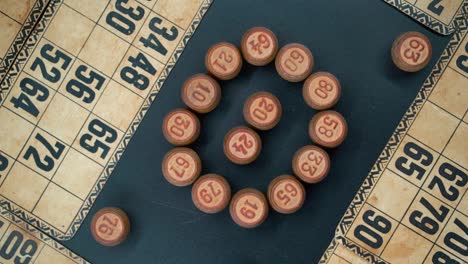 cinematic close-up smooth zoom in rotating shot from above of a bingo wooden barrels in a circle, woody figures, old numbers background, vintage board game, professional lighting, slow motion 120 fps