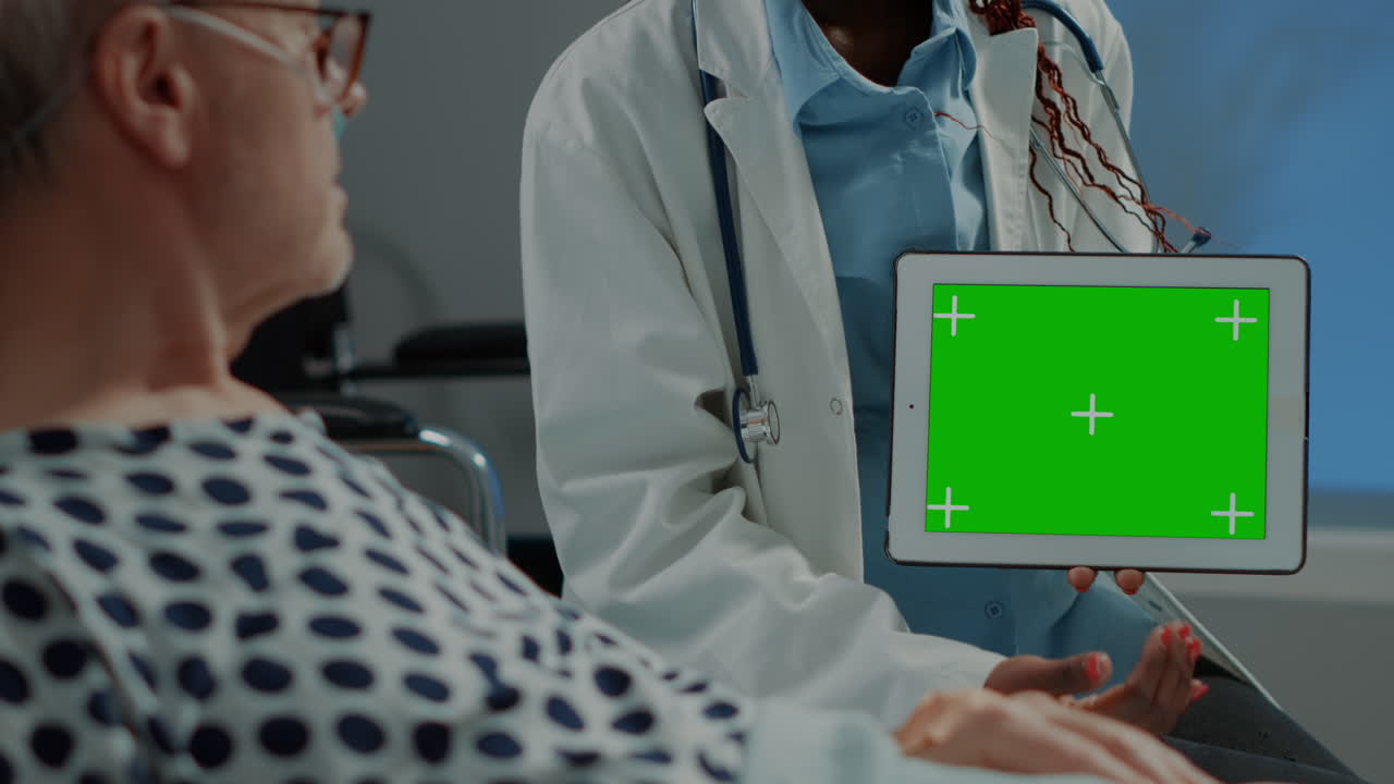 Medical practitioner revealing green screen on tablet