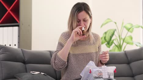 woman using nasal spray for cold or allergy relief