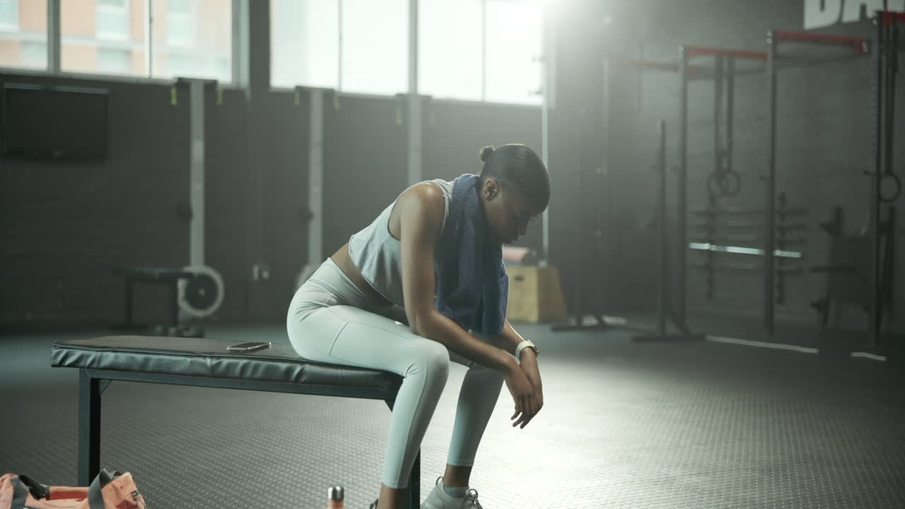 A woman takes a break from exercising