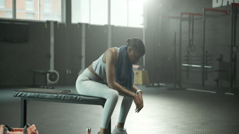 a woman takes a break from exercising
