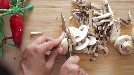 chopping mushrooms on a wooden cutting board