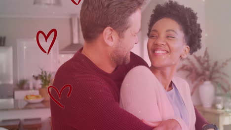 animation of hearts and light spots over diverse couple embracing in kitchen