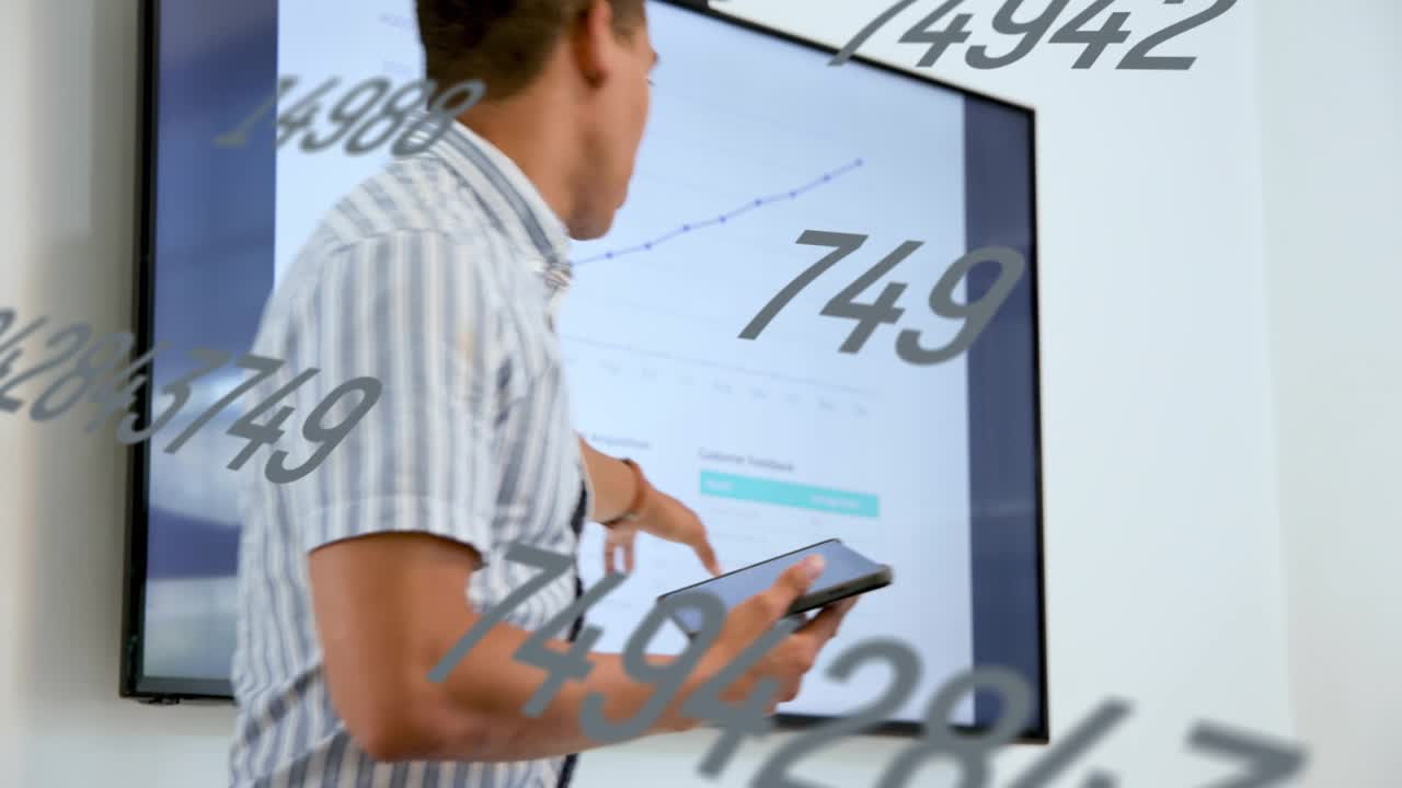 Male host tapping tablet pointing at display marking chart showing business data floating overlays