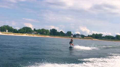 girl wakeboarding on the lake in slow mo