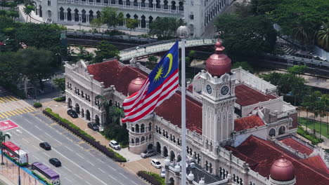 drone orbiting the malaysian flag in downtown kuala lumpur, sunny day in malaysia