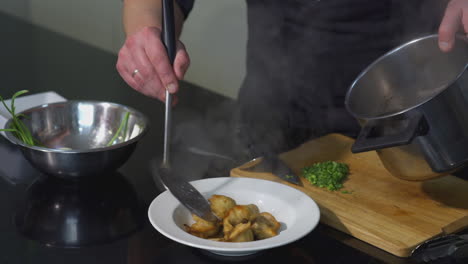 chef preparing dumplings in soup