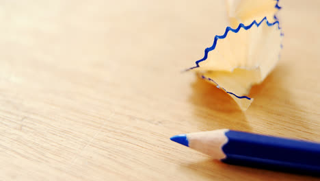 Close-up-of-blue-colored-pencil-with-shavings