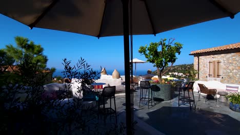 mediterranean stone houses with white walls and balcony overlooking blue sea, summer vacation resort in albania