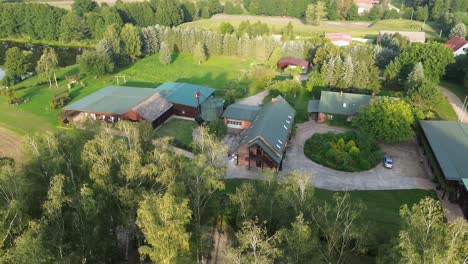 aerial view circulating left above old polish farm in sunny day