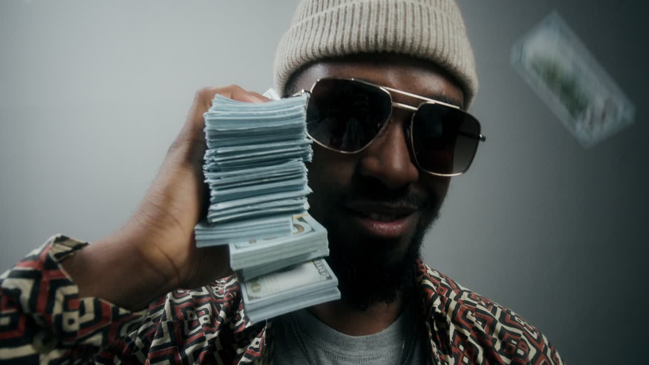 Man celebrating success with cash raining down