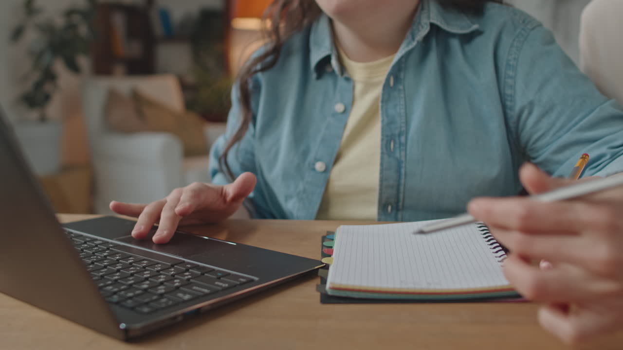 Woman Studying with Laptop and Notepad