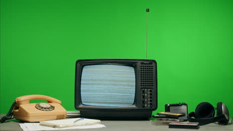 a retro tv displaying static noise, creating a nostalgic vintage atmosphere with blue and green hues.