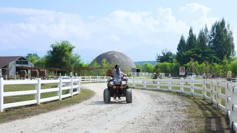 person riding an atv on a gravel path