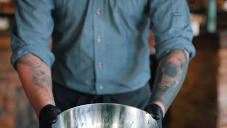 cook mixes the fresh salad in a bowl close up slow motion