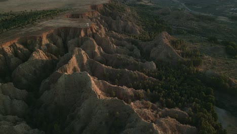 mountainous desert landscape at sunset. geology. erosion effect. ravine and gullies at sunset, aerial view. badlands. climate change and desertification. viewpoint of the end of the world