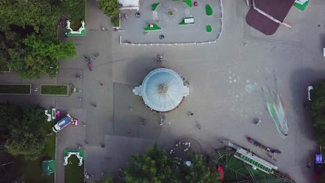 aerial view of a city park with amusement rides and people