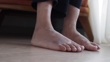 close-up of bare feet on a wooden floor