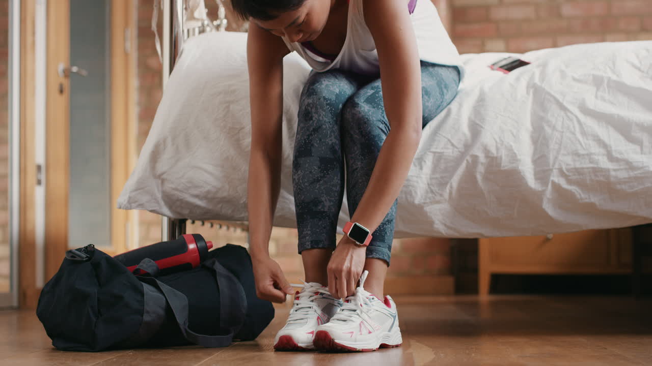 Healthy woman at home getting ready for gym workout with smart watch