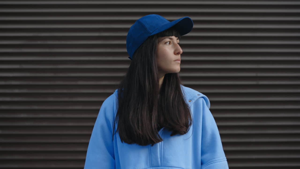 Portrait of a woman in a blue hoodie and cap