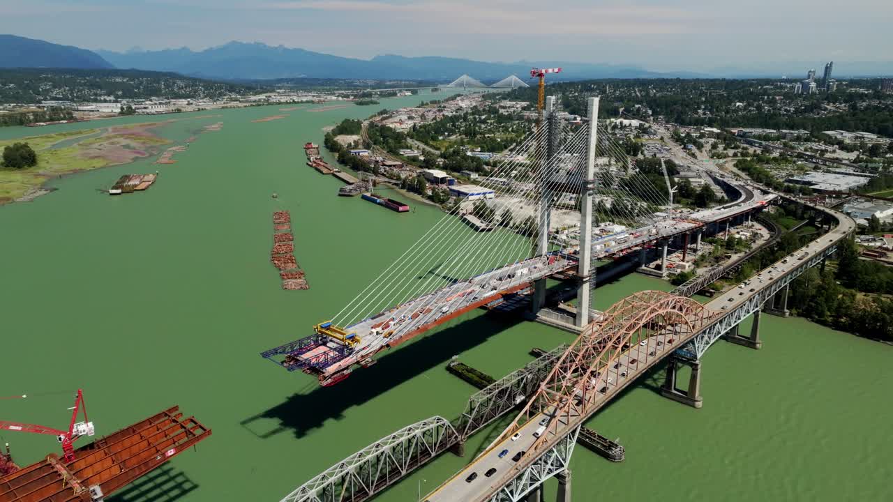 Under Construction Of Pattullo Bridge Spanning The Fraser River With Traffic on Old Pattullo Bridge In BC, Canada. - aerial shot
