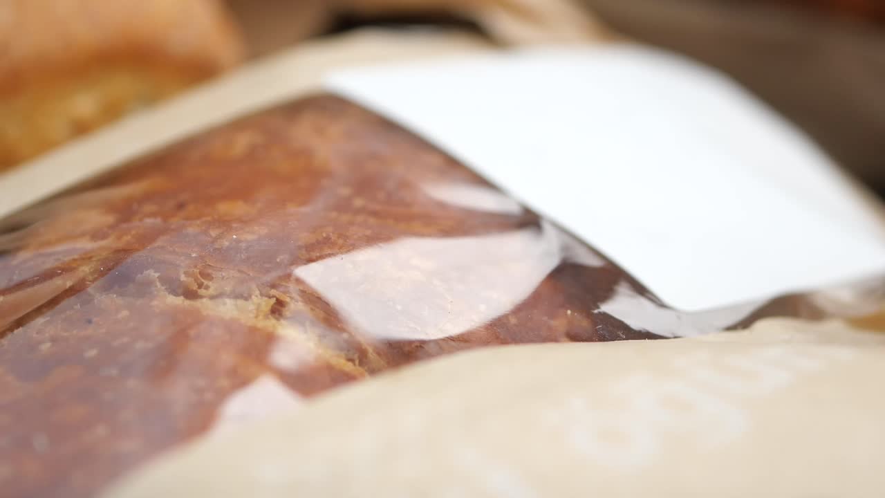 Close-up of a loaf of bread in plastic wrap