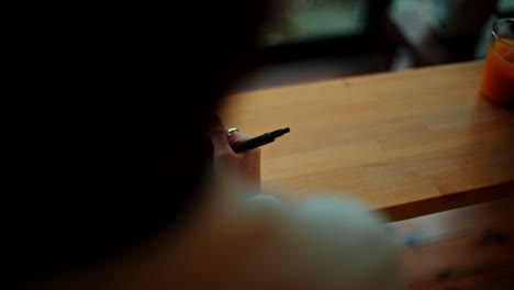 woman writing notes on a notepad