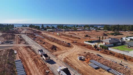 large construction site with earthmoving equipment and pipes near residential area in yarrawonga