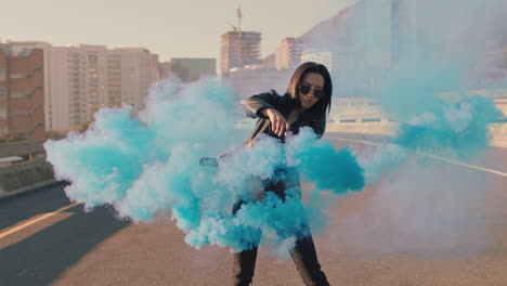 girl dancing with blue smoke grenade in city street young woman hip hop dancer celebrating creative expression with dance slow motion