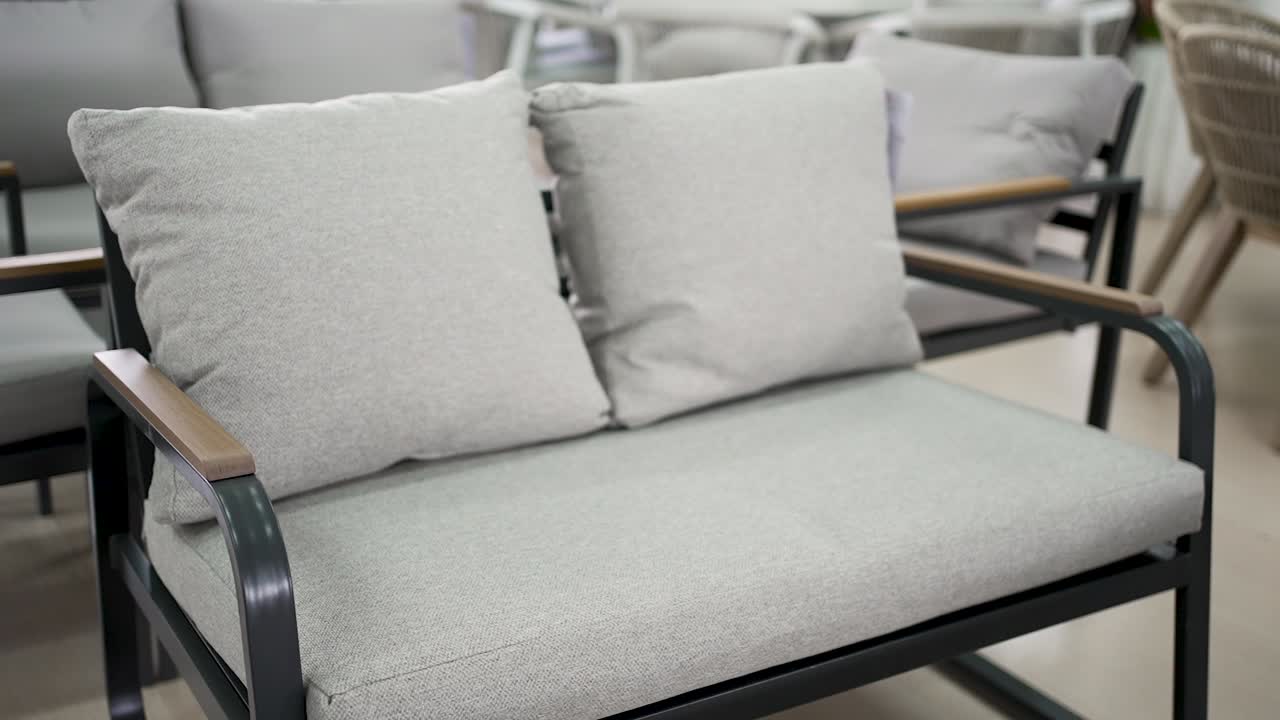 This sleek gray outdoor sofa showcases modern design with soft cushions, perfect for enjoying time in your garden or on your patio with friends and family