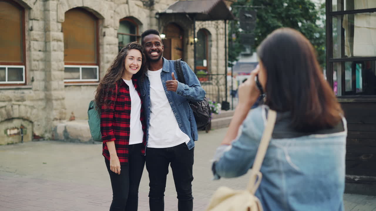 Friends taking pictures in a city