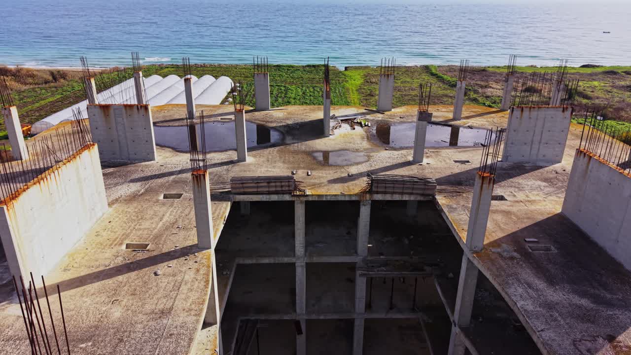 Ocean-view construction site with concrete pillars and foundations