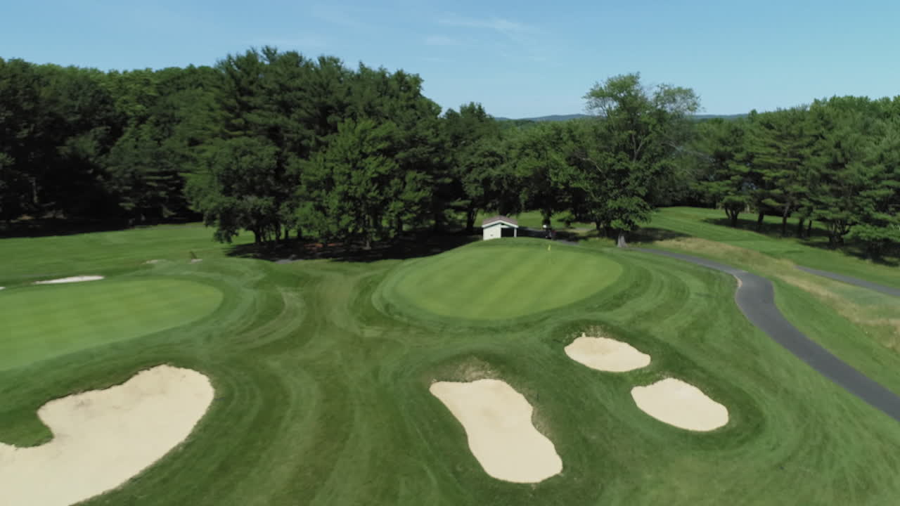 Aerial flyover fairway approaching green hole 11, River Vale Golf Course. Beautiful clear and sunny day.