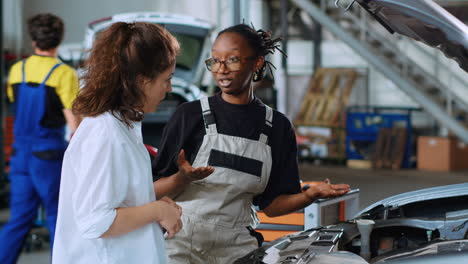 worker does car maintenance for client