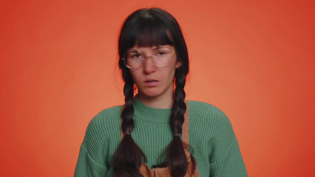 Woman showing nonsense gesture with hands and rolling eyes, gossips, empty promises, blah, liars