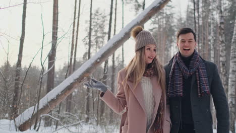 happy young couple in winter park having fun.family outdoors. love