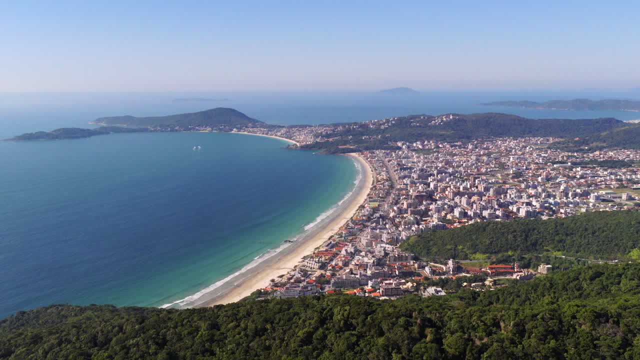 Aerial view of Bombas and Bombinhas Beach, Brazil, with turquoise sea and vibrant city coastline