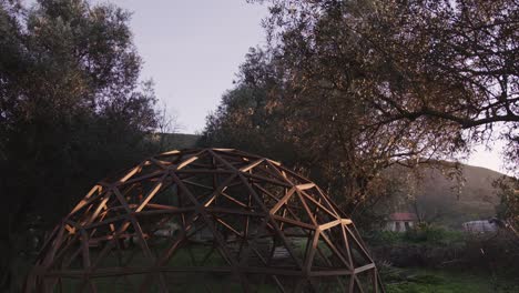 wide shot of wooden hexagonal geodome structure outdoors