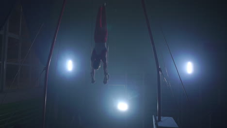 Gymnast-performing-gymnastic-cross-exercise-on-gymnastic-rings.-Shot-in-slow-motion.