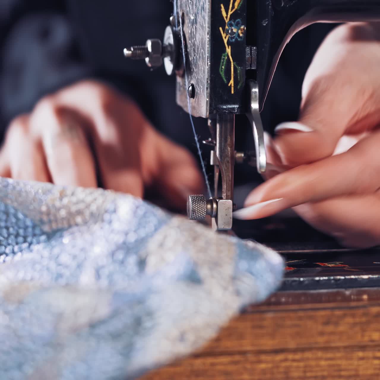 Woman hands behind sewing